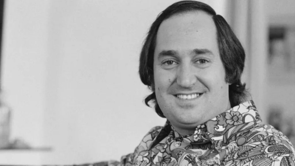 Black-and-white photo of Neil Sedaka wearing a 1970s-style shirt during his music career