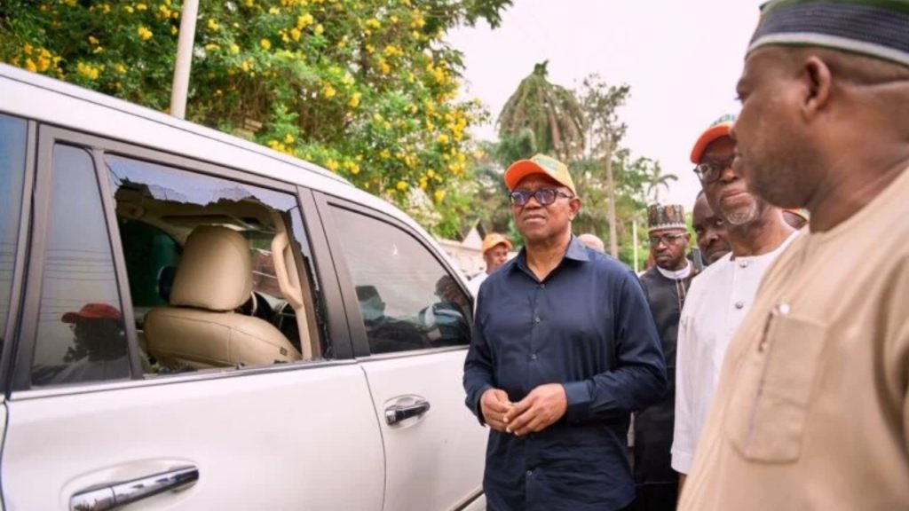 Peter Obi and some of the ADC chieftains examining the damaged cars and bullet riddled gates after the attack by the assailants in Edo State