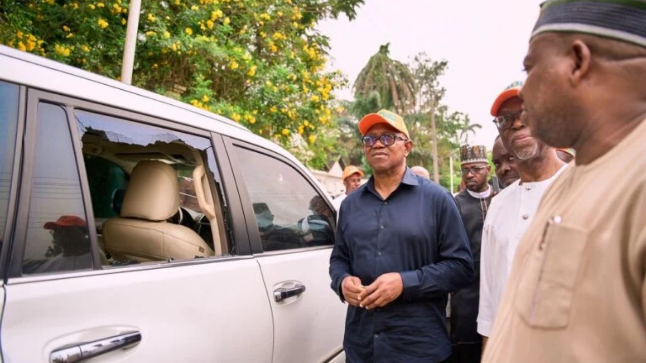 Peter Obi and some of the ADC chieftains examining the damaged cars and bullet riddled gates after the attack by the assailants in Edo State