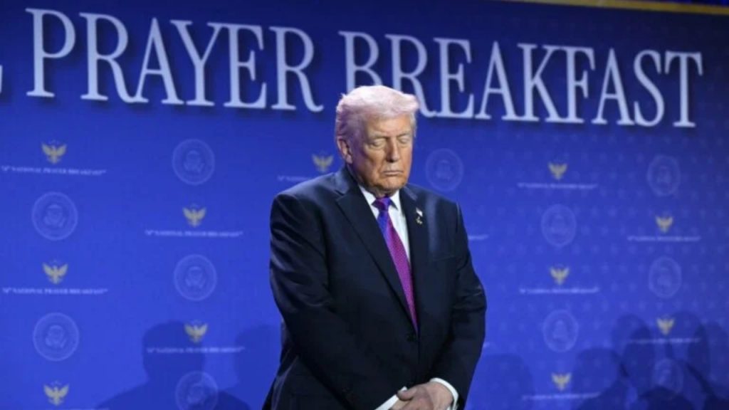 US President Donald Trump bows his head in prayer during the National Prayer Breakfast at the Washington Hilton in Washington, DC on February 5, 2026