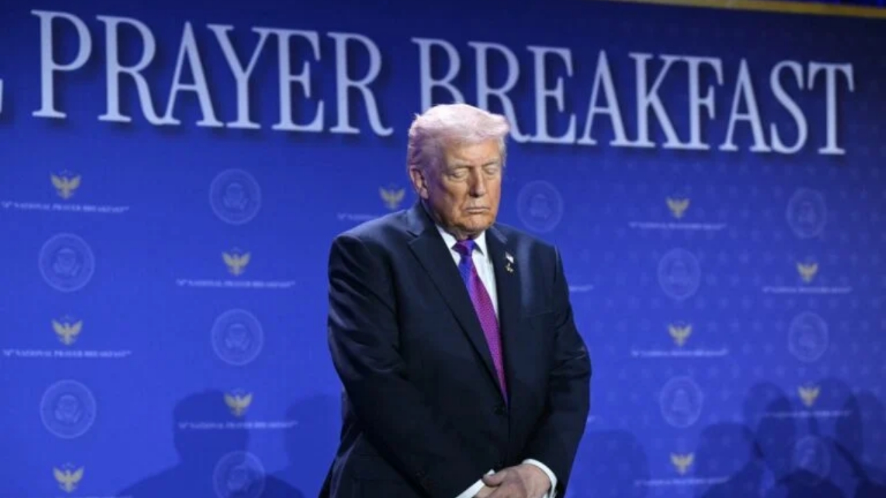 US President Donald Trump bows his head in prayer during the National Prayer Breakfast at the Washington Hilton in Washington, DC on February 5, 2026