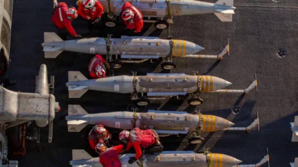 US Navy aircraft carrier preparing munitions