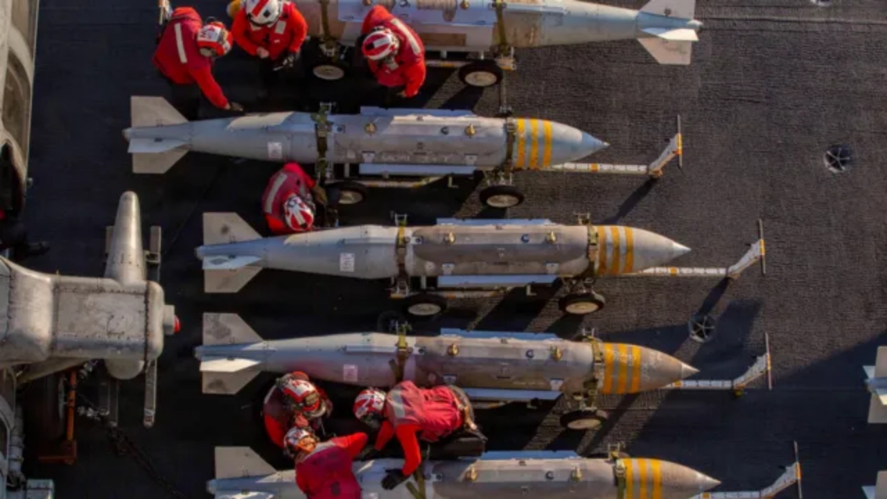 US Navy aircraft carrier preparing munitions