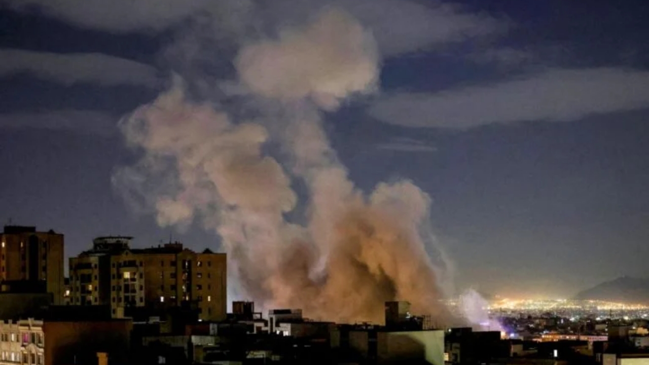 A smoke plume rises following a missile strike on a building in Tehran on March 1, 2026