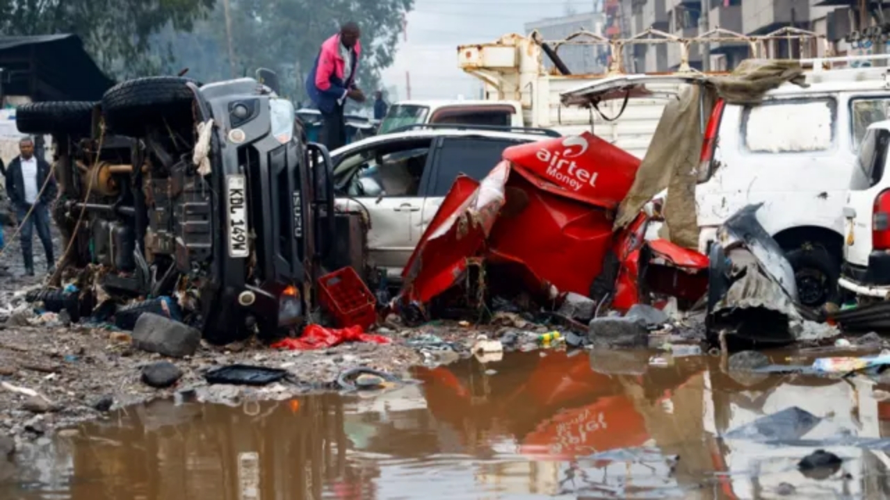 Kenyan man crossing flooded road during severe rainfall in Nairobi