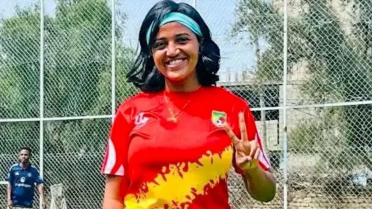 Abeba Amdu raising a victory sign at a football ground, Mekelle, Ethiopia.
