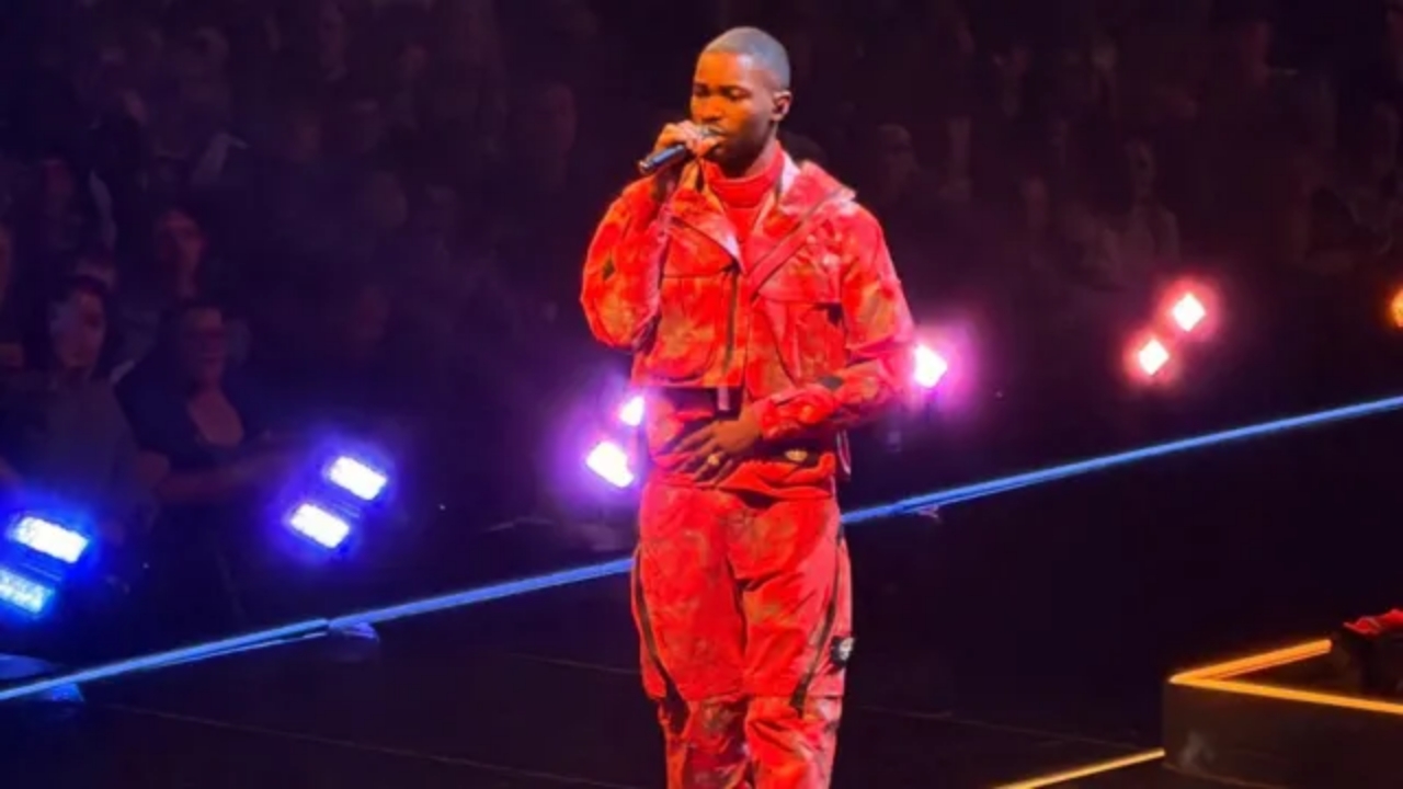 Dave performing live on stage at London’s O2 Arena during his 10-year music anniversary concert.