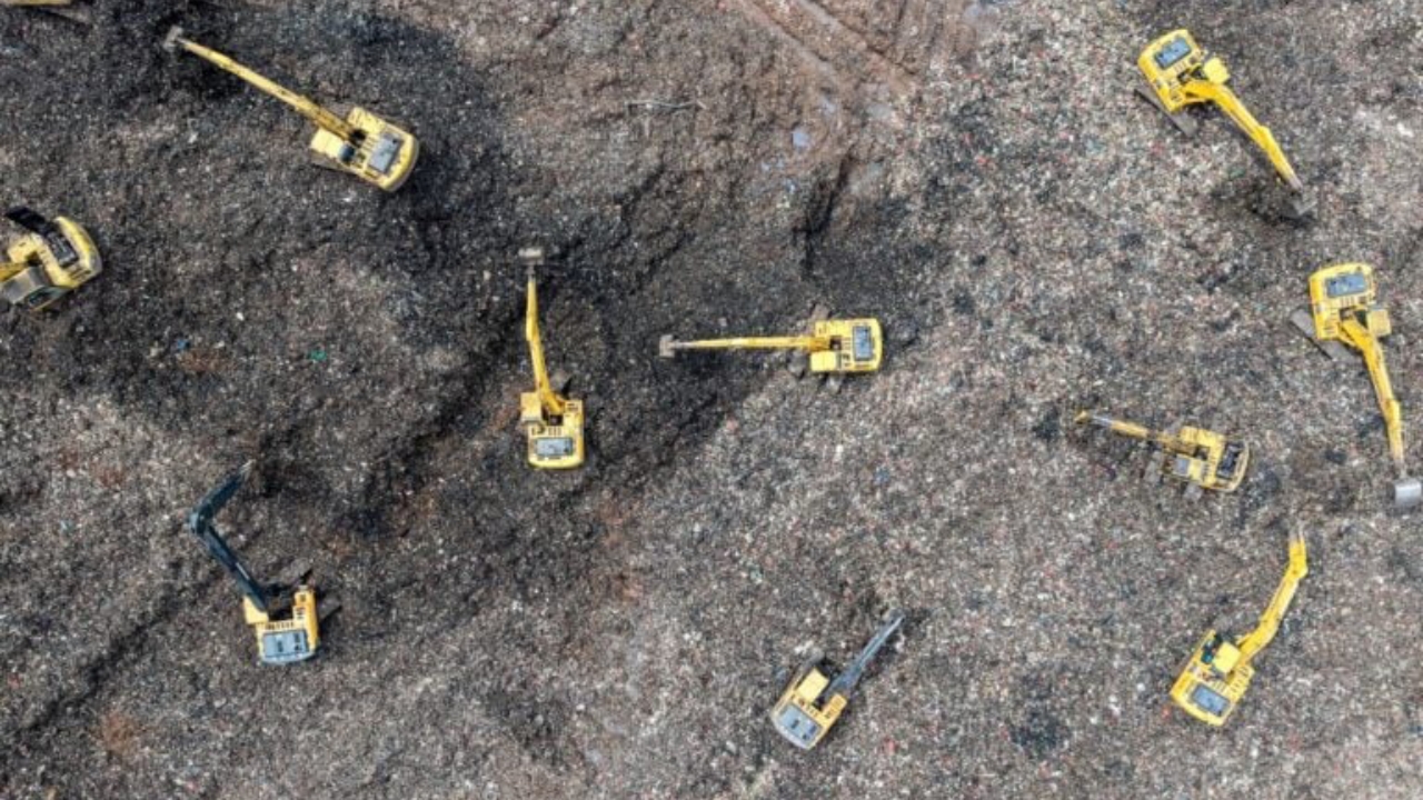 This aerial picture shows a rescue team using heavy machinery to search for people following a landslide at Bantargebang landfill in Bekasi, West Java, on March 9, 2026.