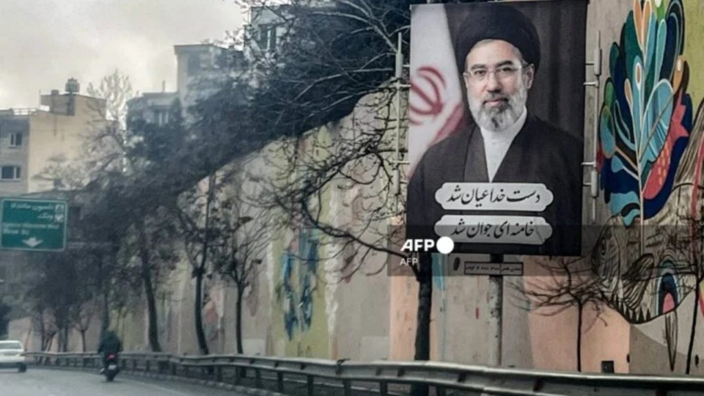 A banner depicting Iran's new Supreme Leader Ayatollah Mojtaba Khamenei is displayed on the side of a highway in Tehran on March 10, 2026.