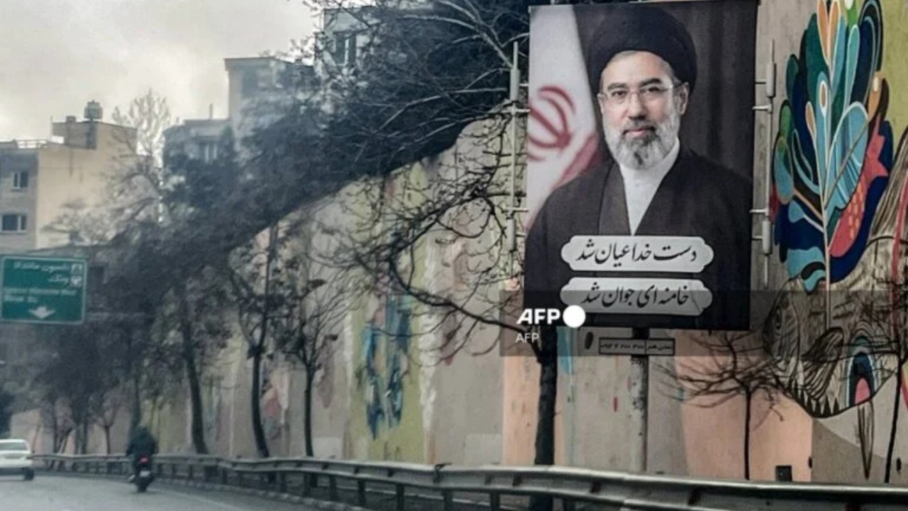 A banner depicting Iran's new Supreme Leader Ayatollah Mojtaba Khamenei is displayed on the side of a highway in Tehran on March 10, 2026.