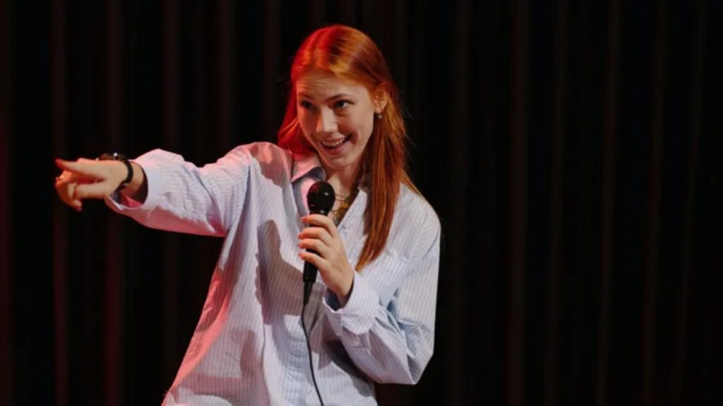 British stand-up comedian performing on stage - National News