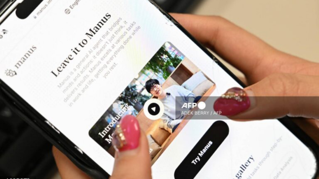 A photo illustration taken in Beijing on March 11, 2025 shows a mobile phone displaying an introduction screen for the AI assistant tool Manus, released by Chinese startup Butterfly Effect. China has blocked Meta's acquisition of AI startup Manus, the country's top economic planning body said on April 27, 2026, following media reports last month that Beijing had restricted two co-founders from leaving the country - National News