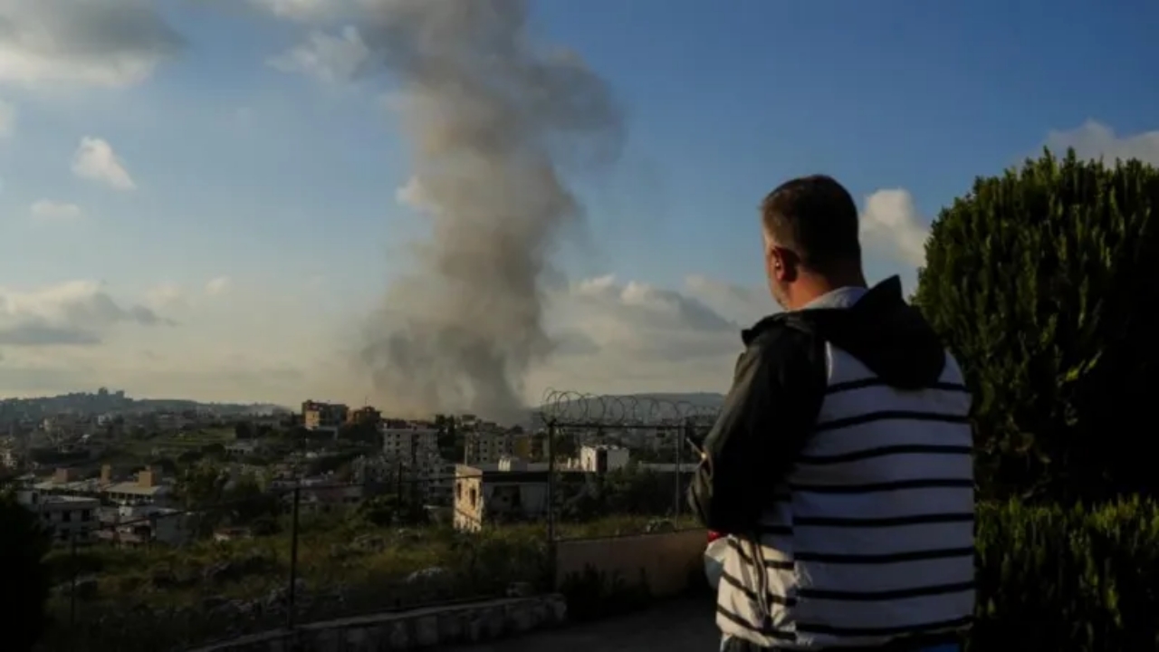 A man looks on following an air strike on Haboush in southern Lebanon on 1 May - National News
