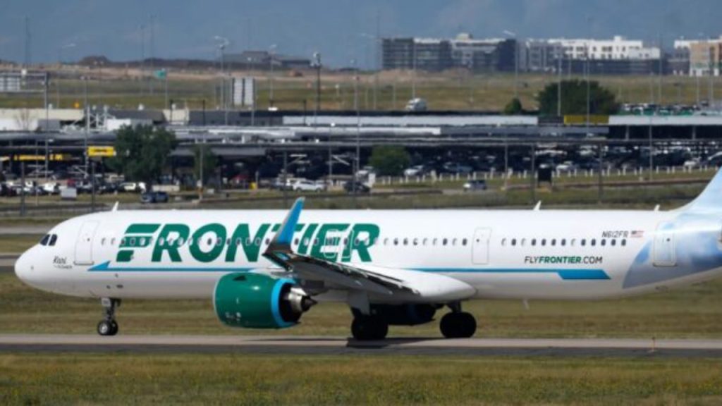 A Frontier Airlines flight waits on a runway for take-off at Denver International Airport - National News