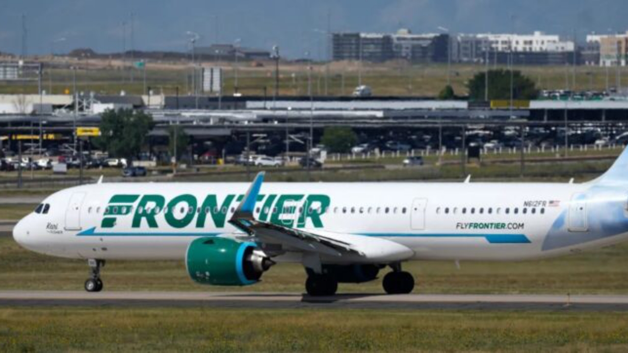 A Frontier Airlines flight waits on a runway for take-off at Denver International Airport - National News