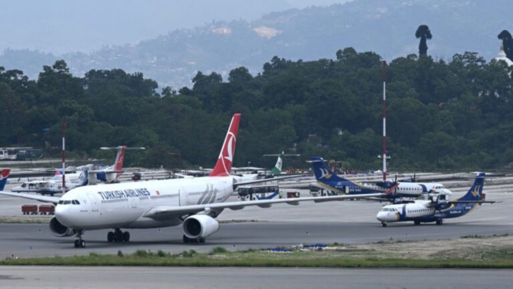 A Turkish Airlines aircraft (L) is parked on the tarmac at the Tribhuvan International Airport in Kathmandu on May 11, 2026. A Turkish Airlines plane carrying 277 passengers and 11 crew members caught fire while landing at Kathmandu airport on May 11, but no one was hurt in the accident - National News