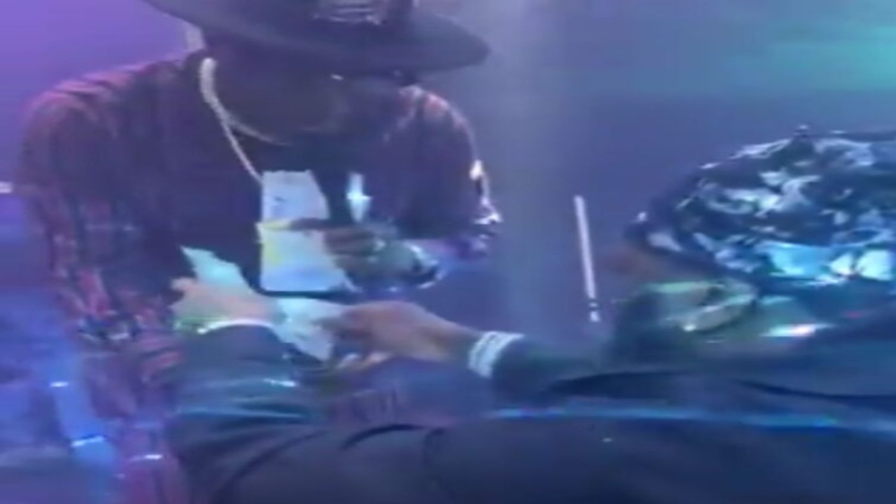 Burna Boy spraying dollar notes on Adewale Ayuba - National News