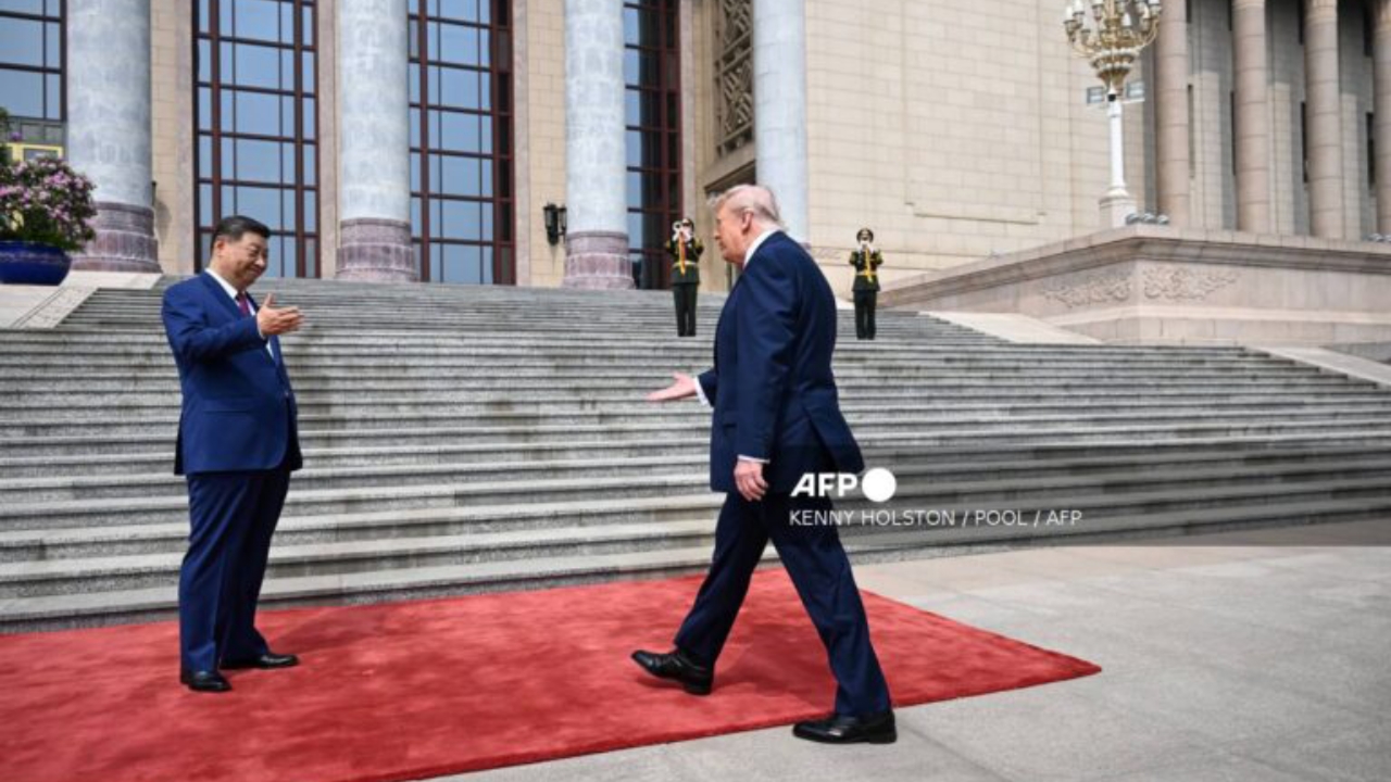 US President Donald Trump (R) prepares to shakes hands with China's President Xi Jinping during a welcome ceremony at the Great Hall of the People in Beijing on May 14, 2026 - National News