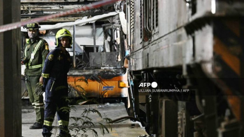 Rescue workers stand at the site of a train collision with a bus underneath Makkasan Airport Rail station in Bangkok on May 16, 2026. A collision between a freight train and a bus killed at least eight people and injured more than 30 in the Thai capital Bangkok, emergency services said - National News