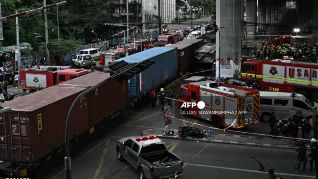 Police officers, rescue workers and firefighters stand at the site of a train collision with a bus underneath Makkasan Airport Rail station in Bangkok on May 16, 2026. A collision between a freight train and a bus killed at least eight people and injured more than 30 in the Thai capital Bangkok, emergency services said - National News